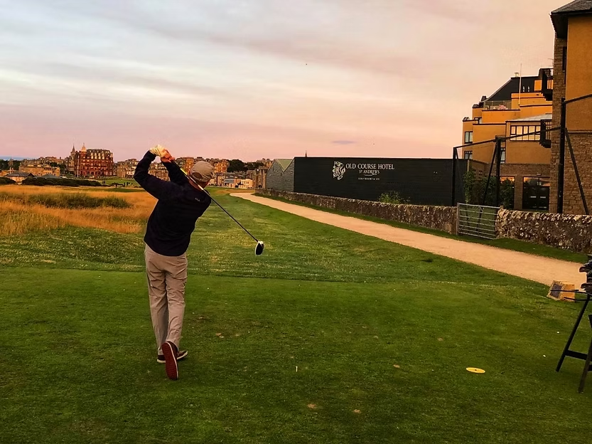 Road Hole - 17th at St. Andrews, is renowned for its difficulty, featuring a tee shot over The Old Course Hotel and hazards like a pot bunker and road near the green.